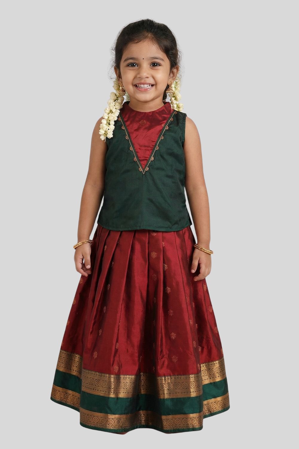 Chittythalli Girls Traditional Pavadai Set | Art Silk Green Sleeveless Top with Red Neck Tie Panel | Minimal Embroidery Hemline | Maroon Knife Pleated Skirt | Woven Ethnic Wear for Girls - PS008