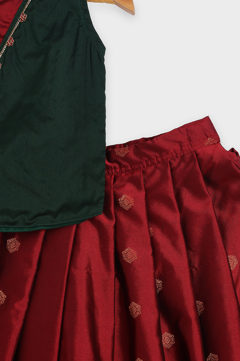 Chittythalli Girls Traditional Pavadai Set | Art Silk Green Sleeveless Top with Red Neck Tie Panel | Minimal Embroidery Hemline | Maroon Knife Pleated Skirt | Woven Ethnic Wear for Girls - PS008