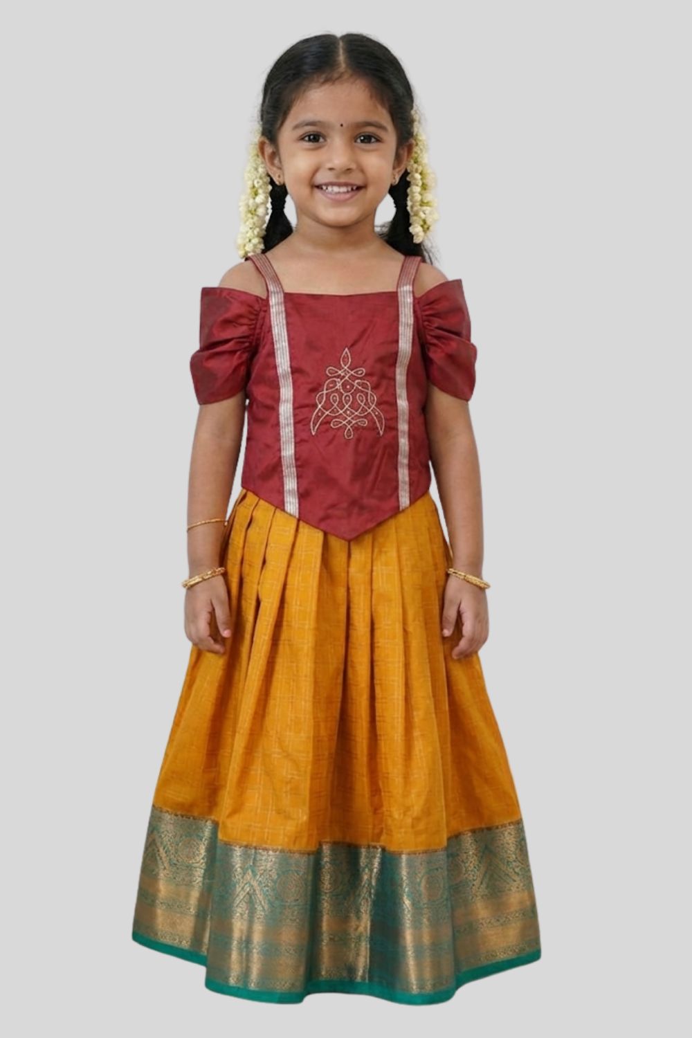 Chittythalli Girls Traditional Pavadai Set | Art Silk V-Cut Maroon Top with Gathered Cold Shoulder Sleeves & Kolam Motif Embroidery | Green Knife Pleated Skirt | Back Open Gold Button | Woven Ethnic Wear for Girls - PS005