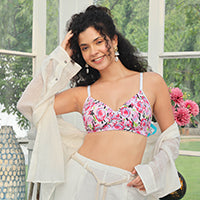 Woman wearing a pink floral padded bra with a white shirt