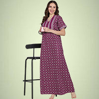 Woman wearing a purple printed nightdress and holding a mug